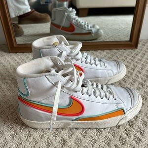 Nike White High-Top Sneakers with Orange and Red Swoosh Accents